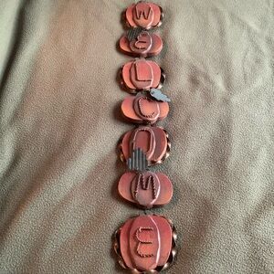 Cute wood and metal hanging pumpkin welcome sign. Approximately 26 1/2” long